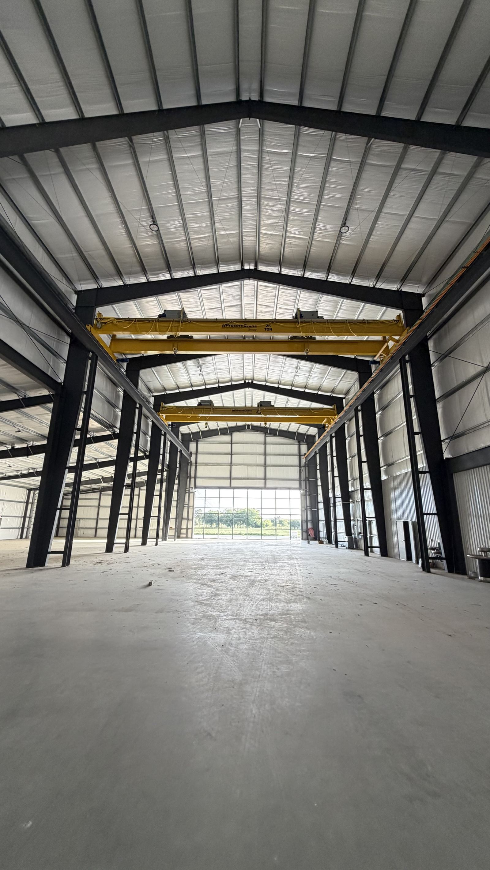 Interior of a Rhodes Building Systems metal building with twin 25-ton overhead cranes