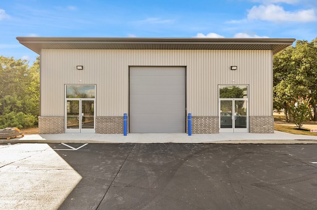 Office and warehouse metal building in College Station, Texas with a centered 14 foot overhead door between two glass entries and a brick wainscot