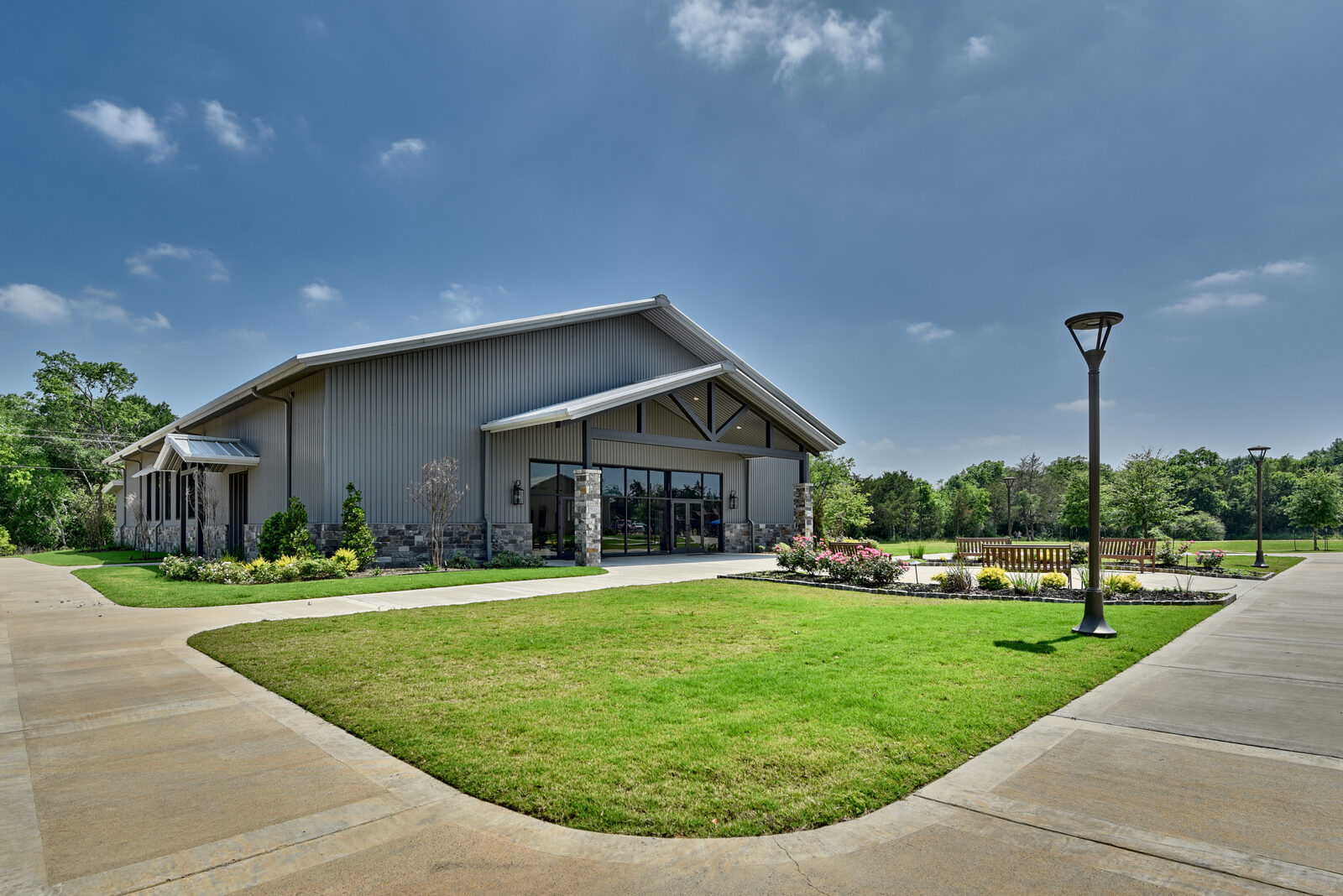 Three-quarter exterior view showing the extended roofline and the steel-truss entry with full soffit