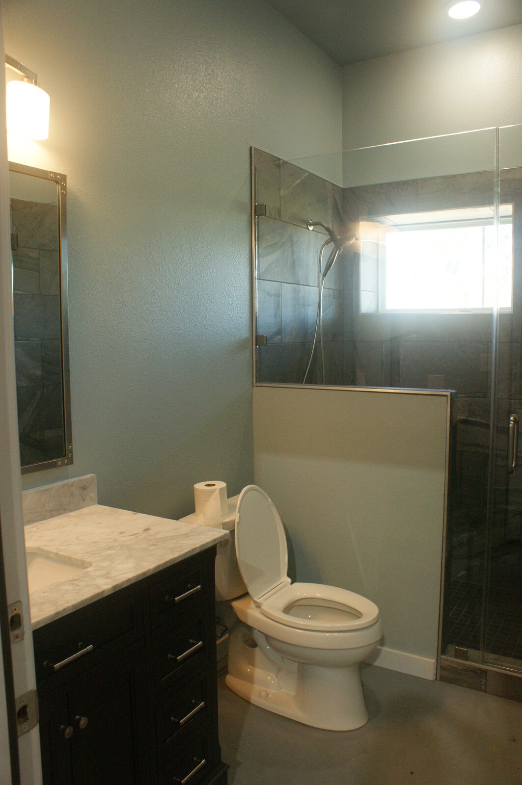 Finished bathroom with a vanity and tiled walk-in shower