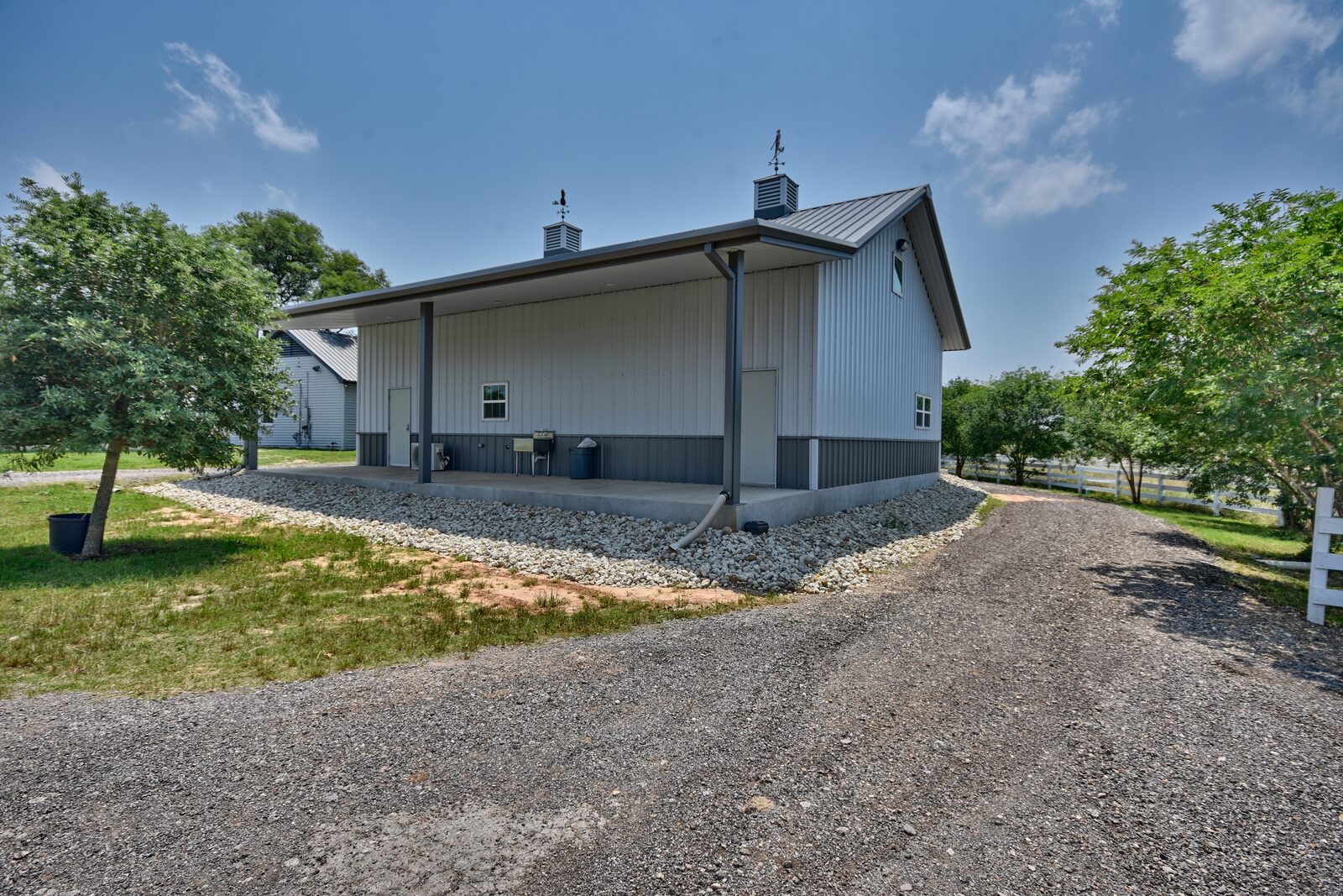 Rear three-quarter view showing the deep covered porch and its seamless roof transition