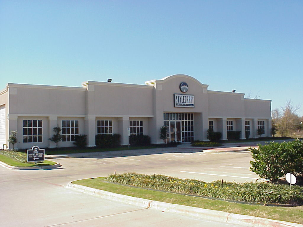 Stylecraft Builders sales centre, a single-storey commercial building with a stucco facade and arched parapet